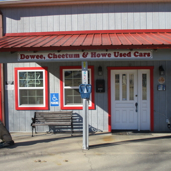Garage Exterior with Bench Parking Meter and Dog Statue - TIME OUT GARAGE from LOWELL, AR