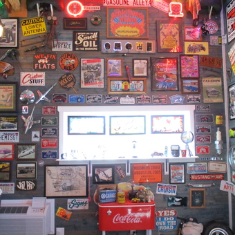 Garage wall with vintage signs, neon lights, and Coca-Cola cooler - TIME OUT GARAGE from LOWELL, AR