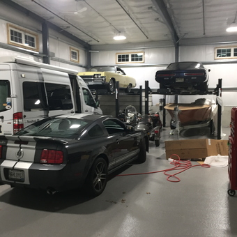 Spacious garage with car lift, tool chest, and vehicles - Jim from Freeport, ME