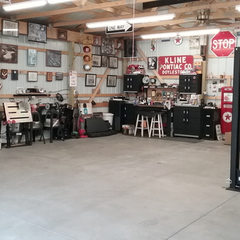 Organized garage with cabinets, car lift, and decor - Tpcaz from Niagara Falls, NY
