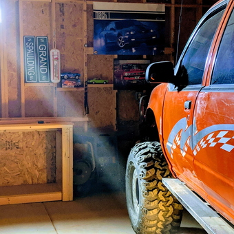 Garage With Off-Road Truck, Street Signs, And Workbench - Rick from AZ