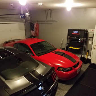 Organized garage with two Mustangs and storage shelves - Phil from Keene, NH