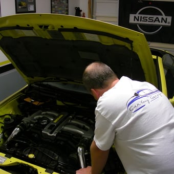 Yellow Nissan Garage With Wall Decor And Open Hood - Aaron from Farmington, UT