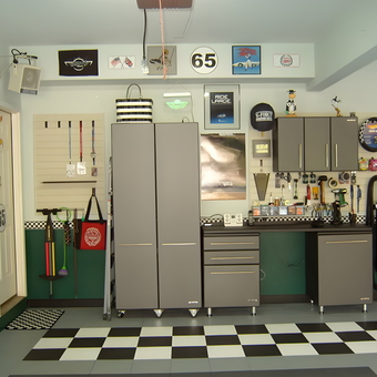 Organized garage with cabinets, tool storage, and checkerboard floor - Annette from Milton, GA