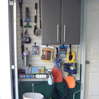 Organized garage wall with cabinet and cleaning tools - Annette from Milton, GA