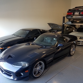 Four classic sports cars with car lift in clean garage - Guilly from PHOENIX, AZ