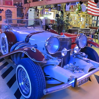 Classic Car Display with Garage Decor and Memorabilia - Didier