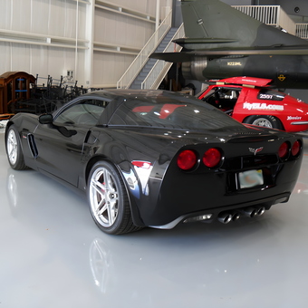 Black Corvette and Race Car in Spacious Garage - Bill