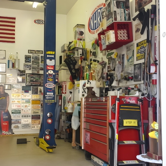 Organized garage with tool chest, car lift, and decor - GATOR from SPRINGFIELD, NJ
