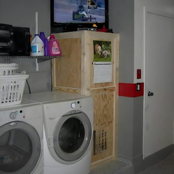 Garage laundry area with washer, dryer, TV, and storage - BigHen from Sunrise, FL