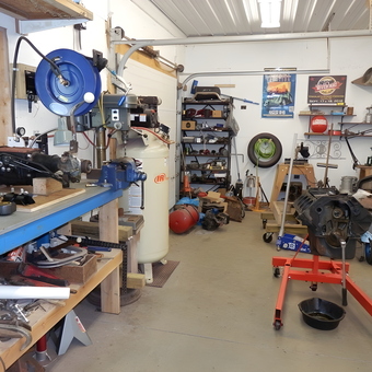 Organized garage with workbench, air compressor, and engine stand - Richard from Sterling, NY