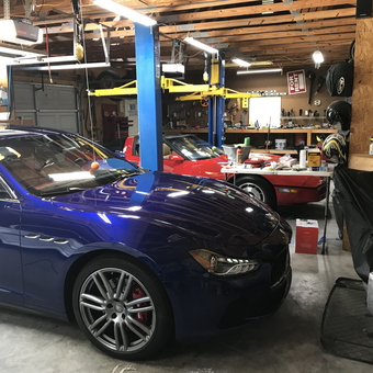 Organized garage with car lift, tool bench, and Maserati - Ben from Florence, SC
