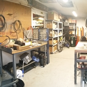 Organized garage with workbenches, compressor, and storage shelves - Rob from Garden City, MI
