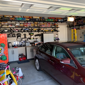 Organized garage with display shelves, cabinets, and car - Andy from Mechanicsburg, PA