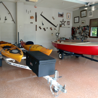 Organized garage with kayaks, boat, trailers, and wall tools - Kayakjohn from Mount Nebo, WV