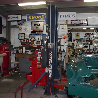 Organized garage with car lift, tool chests, and signs - Chuck from Gainesville, GA