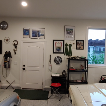 Organized garage with wall art, hubcaps, and car memorabilia - Bud from LOVELAND, OH