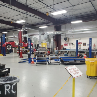 Organized garage with car lifts, tool carts, and safety bins - Kenny from Sun City West, AZ