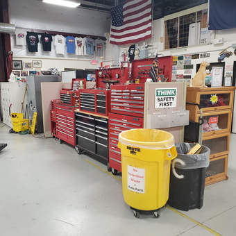 Organized garage with tool chests, lift, bins, and wall decor - Kenny from Sun City West, AZ