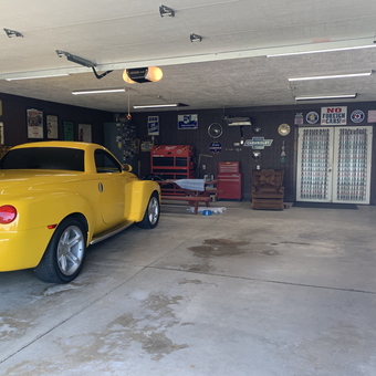 Organized garage with tool chests, signs, and yellow car - Terry from Mineral Ridge, OH