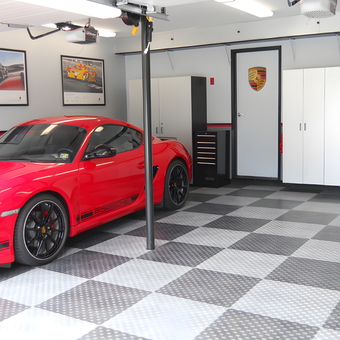 Modern garage with red Porsche, cabinets, and tile flooring - Jim from Commack, NY