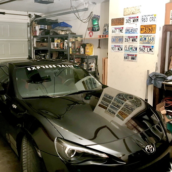 Organized Garage with Shelving, License Plates, and Toyota - Rage Fueled from Farmington, AR