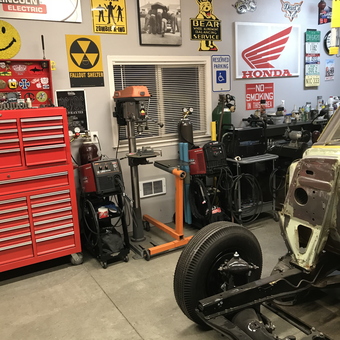 Organized garage with tool chest, welders, and wall signs - Greg from Meridian, ID