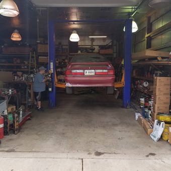 Two post car lift and storage shelves in garage - Moey from Goshen, IN