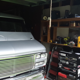 Organized garage with van, tool chest, and shelving - Van Guy from bath, ME