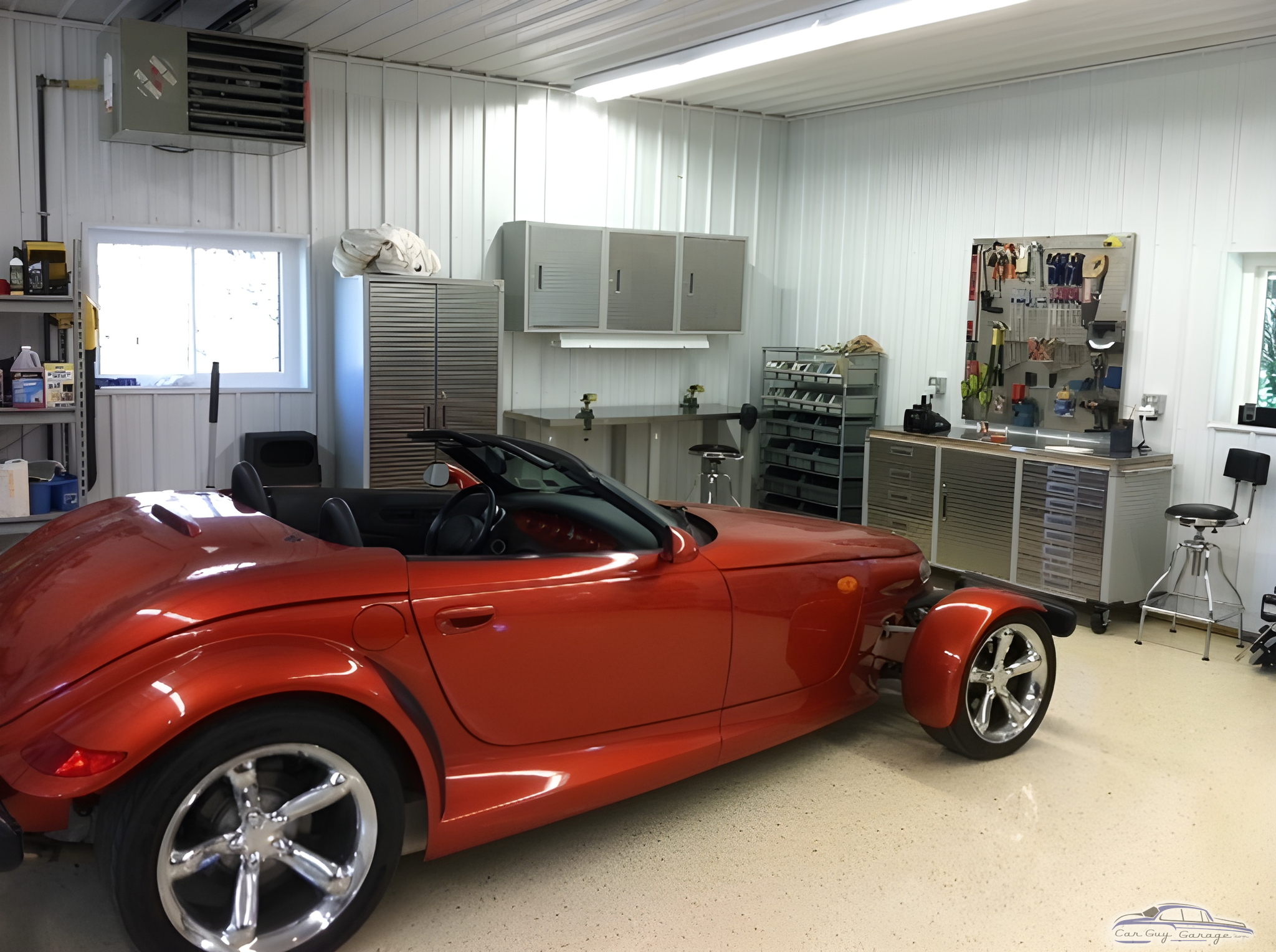 Organized garage with red roadster and metal cabinets - Roger from Falconer, NY