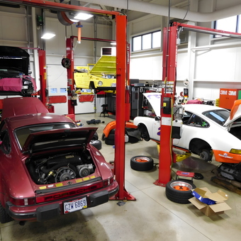 Multiple car lifts and classic Porsches in organized garage - chip from POWELL, OH