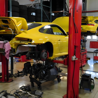 Yellow sports cars on lifts with tools and tire racks - chip from POWELL, OH