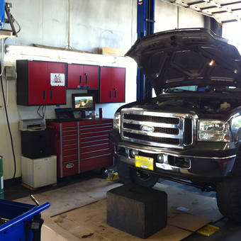 Organized garage with red cabinets and Ford truck - Butler from Ashland, OR