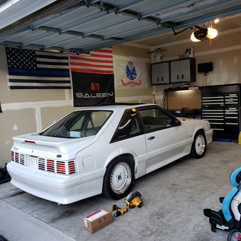 Organized garage with white Mustang, tool chests, and wall cabinets - California edition from martinsburg, WV