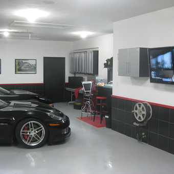 Modern garage with Corvettes, cabinets, and wall TV - Mark from Ft Lauderdale, FL