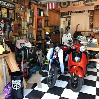 Organized garage with scooters, tools, and Route 66 decor - Mike from Houston, TX