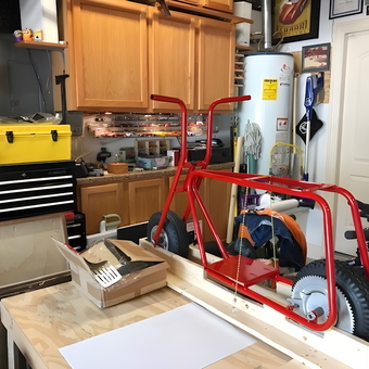 Organized garage workspace with tool chest and minibike frame - Mike from Houston, TX