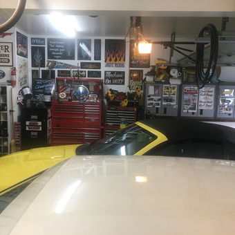 Organized garage with tool chests, wall art, and cars - RICK from West Suffield, CT