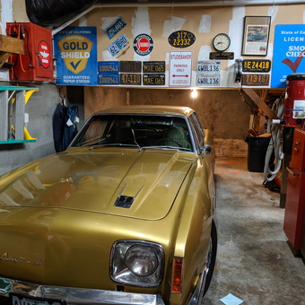 Vintage garage with gold Avanti II and retro signs - sixtyfathom from GOLD BEACH, OR