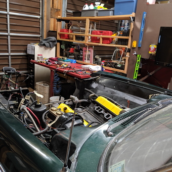 Organized garage with workbench, car project, and tools - sixtyfathom from GOLD BEACH, OR