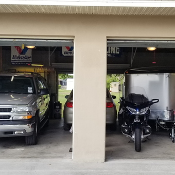 Organized garage with vehicles, trailer, and shelving - CoolBlue87GT from PORT CHARLOTTE, FL