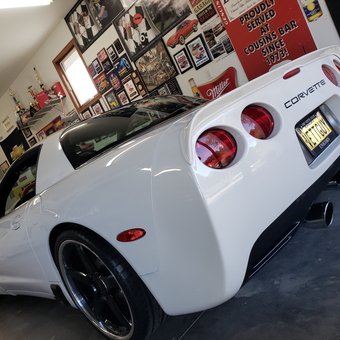 White Corvette in Decorated Garage with Wall Signs - T