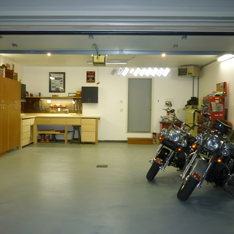 Organized garage with motorcycles, cabinets, and workbench - Joe from Traverse City, MI