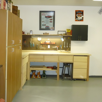 Organized garage workbench with cabinets and pegboard - Joe from Traverse City, MI
