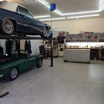 Organized garage with car lift, storage cabinets, and workbench - 3 Speed from Alamo, CA