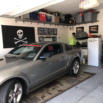 Organized garage with Mustang, wall storage, and flags - Joe from Mesa, AZ