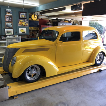 Yellow classic car on lift with garage decor - HOTTAXI from Ventura, CA