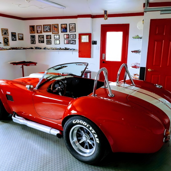 Classic Red Cobra in Decorated Garage with Wall Art - ci-19396