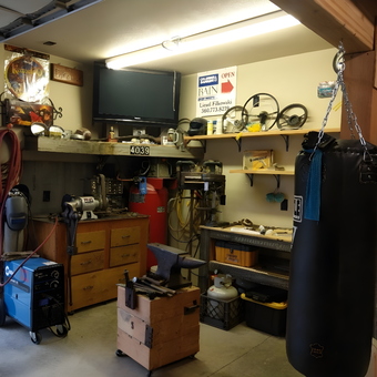 Organized Garage Workshop with Tools, Shelves, and Punching Bag - ci-19401