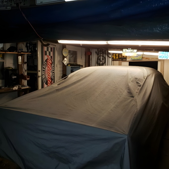 Garage with Covered Car, Lighting, and Wall Signs - ci-19408